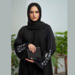 Black Nidha open-front abaya with cutwork and handwork details on sleeves and back – formal modest wear