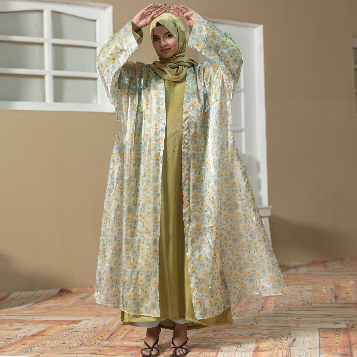 Model wearing Golden Ruya Abaya featuring floral printed outer coat with golden inner dress and matching hijab.