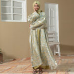 Model wearing Golden Ruya Abaya featuring floral printed outer coat with golden inner dress and matching hijab.