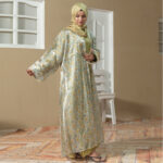 Model wearing Golden Ruya Abaya featuring floral printed outer coat with golden inner dress and matching hijab.